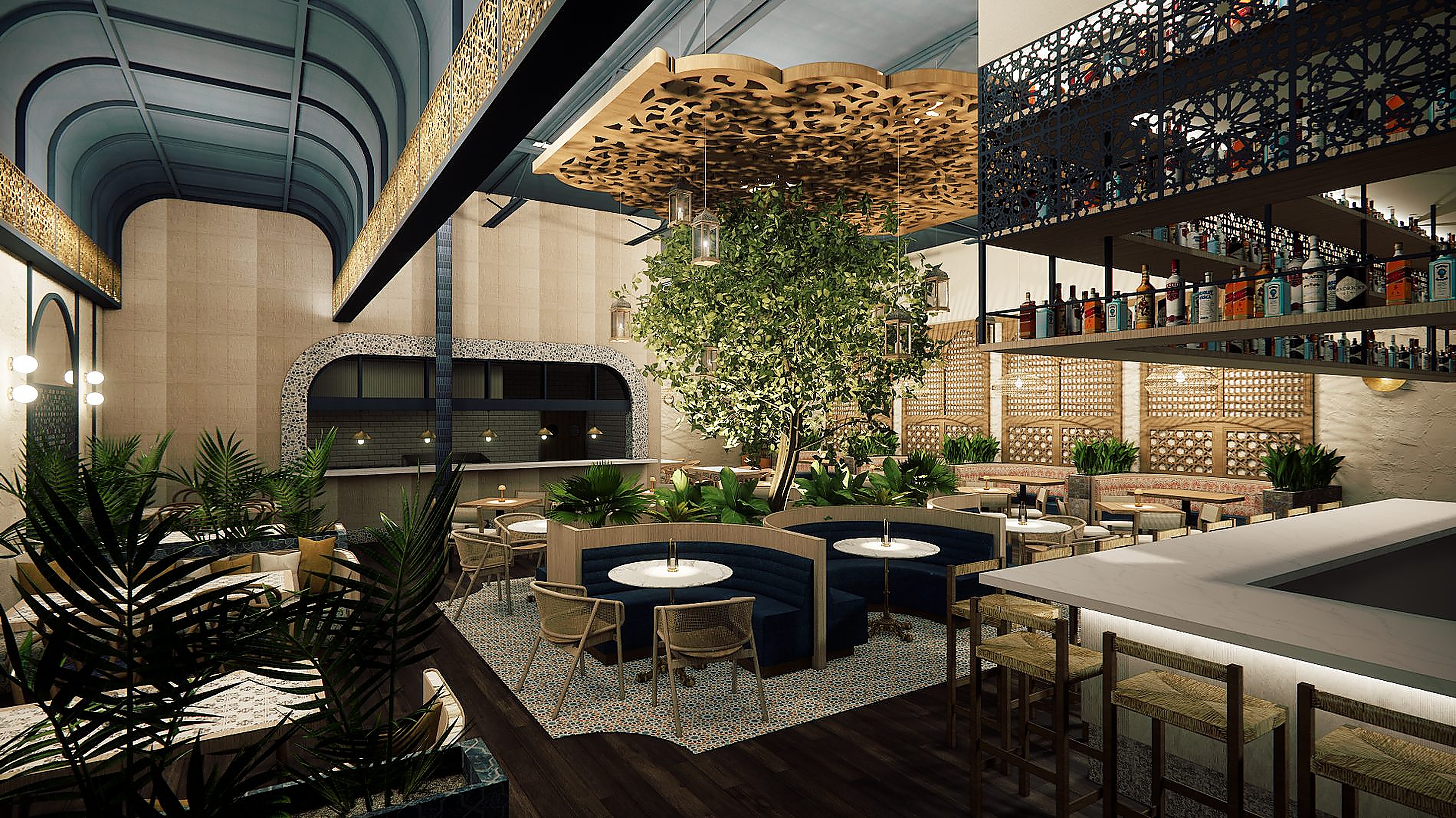 Elevated view across a lounge restaurant — a full-height tree at the centre beneath a carved wooden ceiling panel, curved navy banquettes and marble tables with woven cane chairs on patterned mosaic tile, an arched pass-through lined with mosaic tile, a deep blue barrel-vaulted ceiling to the left, and a marble-topped bar with a backlit front and laser-cut lattice bottle shelves to the right
